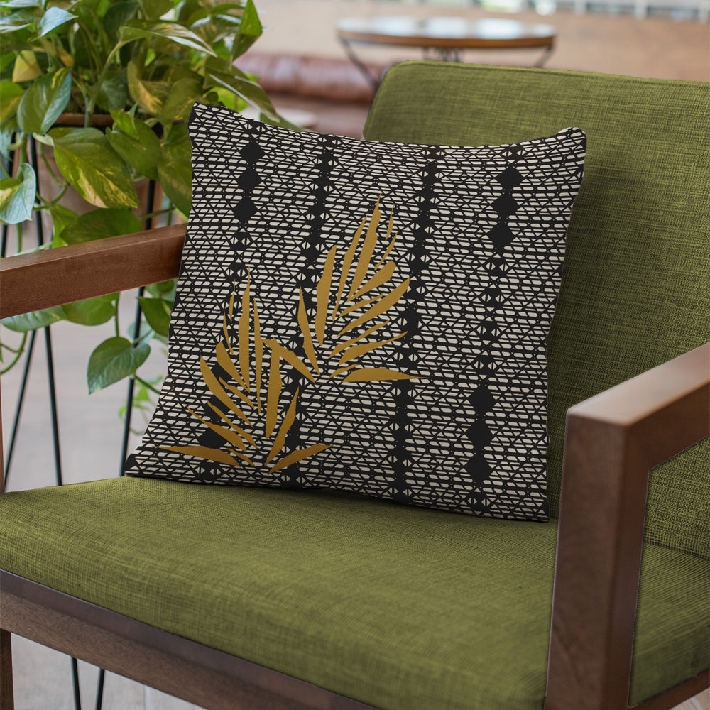 Gold and Black Kanu Square Pillowcase Set On an Olive Colored Chair With Wooden Arms