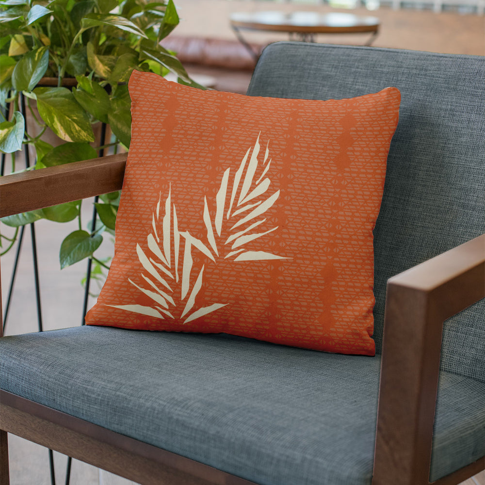 Ivory and Citrus Kanu Square Pillowcase Set On a Blue Colored Chair With Wood Arms