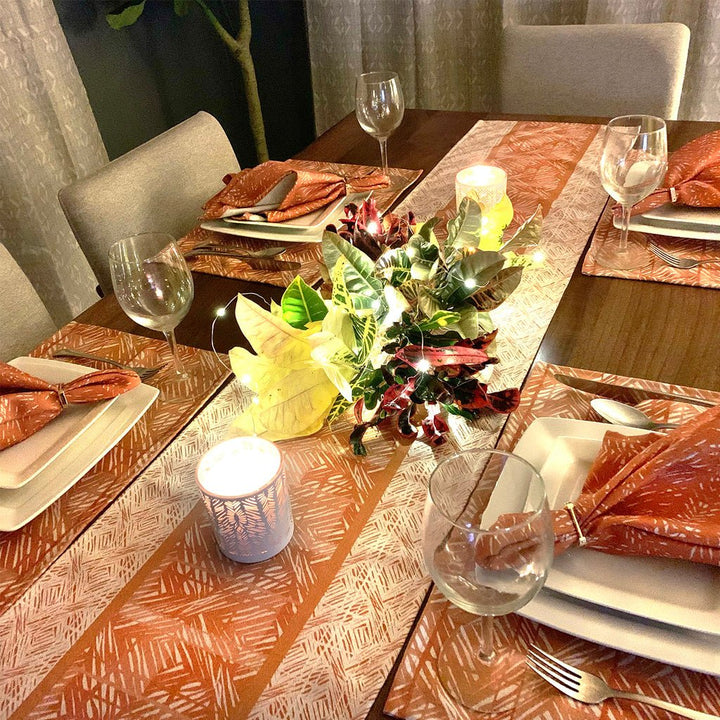 Pumpkin Premium Moena Nui Dining Placemat Sets with Premium Pumpkin Moena Table Runner, candles, centerpiece and stemmed wine glasses.
