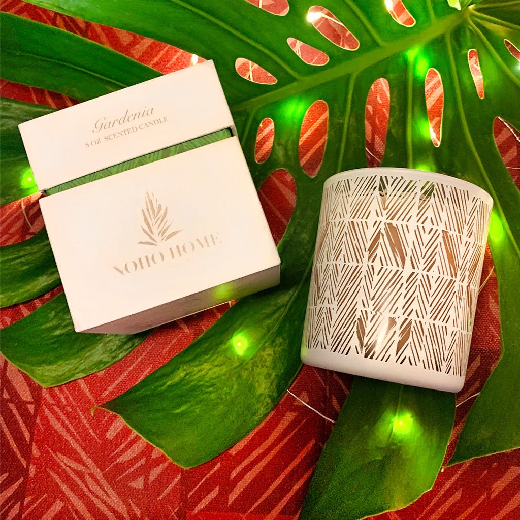 Gardenia Scent Soy Candle atop Monstera leaf and red tablecloth